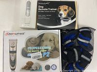Photo showing Baorun P2 dog hair clippers in box, LumoLeaf dog remote trainer box, and mesh bag with dog booties