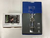 Photo showing unopened Premium Nature Beard Grooming Kit box and Limural F30 Hair Clipper box side by side.