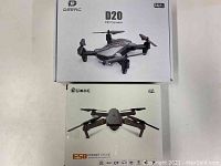 Box showing DEERC D20 mini drone with HD camera and Eachine Pocket Drone E58 box.