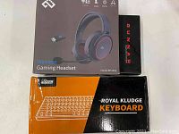 Lot items with their original packaging: Infuture Wireless Gaming Headset BH105A box, Royal Kludge Keyboard box, Gunnar glasses case.