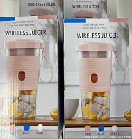 Two boxes of wireless juicers front view showing 'Wireless Juicer' branding and product image with fruit inside and color options at bottom (pink, blue, white)