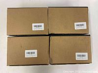 Four unopened lint remover boxes stacked in two rows