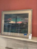 Framed pastel artwork showing overall piece against red wall