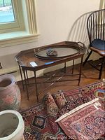 Wooden tray table with oval wooden tray and small trivet placed on top, showing overall lot composition.