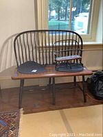 Full view of both full-size bench and matching doll bench placed on top of the larger bench with window background.