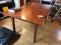 Full view of rectangular wooden table in room setting