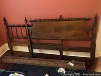 Full view of the antique bed components including headboard, footboard, and side rails laid out, showing the spindle turned decor and wood finish.