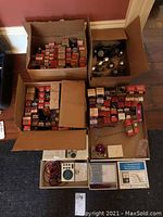 Four open boxes of original tube packaging and bottom tray with testers, leads and manuals