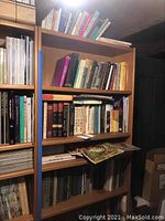 Books on wooden shelves including titles like 'Happy People', 'Toxic Parents', 'Looking Good'