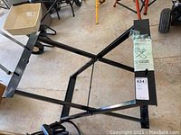 Full view of the black metal folding table stand showing structure and support bars.