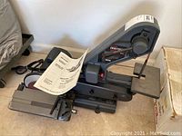 Full side view of the Sears Craftsman belt and disc sander showing the sanding belt, power cord, and worktable.