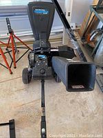 Front view showing hopper, chipper chute, wheels and handle