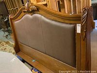 Headboard front view showing wood frame and faux leather upholstery