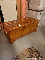 Full view of cedar chest showing overall condition and wood grain pattern.