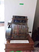 Full view of cash register on wooden stand