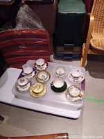 Eight bone china teacup and saucer sets in assorted floral and gold-trimmed patterns