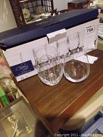 Set of 8 Cheers by Mikasa stemless wine glasses in original box, with two glasses displayed in front.