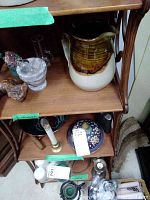 Wooden shelf displaying multiple items including pottery pitcher, marble mortar and pestle, corkscrew, ceramic bowl, metal flask, ginger jar top.