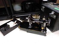 Front view of Singer sewing machine with accessories tray, motor and carrying case