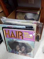 LP record covers in box, focus on Hair soundtrack album cover in front