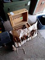 Woodworking chisels in canvas roll and wooden case, multiple chisels with wooden handles visible, some rust on blades.