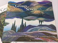 Boxed calendar cover titled 'The Group of Seven' featuring a multi-colored landscape with hills and water in purples and blues