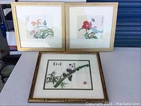 Three framed prints: two floral and one panda print, all Asian style with calligraphy.