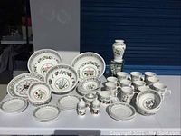 Overview of plates, bowls, mugs and vase arranged on table