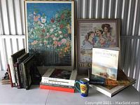 Overall lot: two framed prints, stacks of art books, ceramic mug and bookend