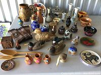 Full table display showing all items arranged including pottery pieces, figurines, and decorative utensils.