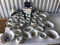 Overview of assorted Royal Worcester fruit pattern pieces including mugs, bowls, lidded dishes, promotional cordialers
