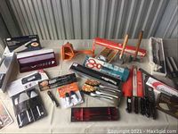 Wide view of assortment on table including knives, server, thermometer and gadgets