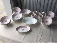 Full set of miscellaneous Johnson Bros. and Wedgwood china items arranged on table including plates, bowls, and mugs.