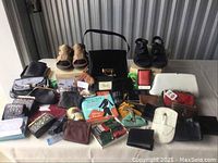 Overview of lot showing two pairs of sandals, three handbags and assorted wallets and coin purses