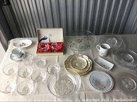Overview of various glass, crystal, and Denby ceramic items on table