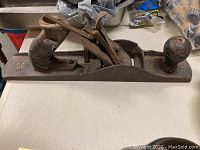 Front view of the 14-inch No 5 hand plane showing metal body, wooden handle and front knob, visible wear and rust.