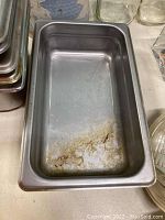 Large rectangular food server pan with wear and stains on interior bottom surface
