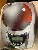 Front view of digital kitchen scale showing weighing platform, LCD display, and control buttons