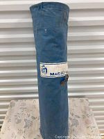 Blue rolled up tent in original storage bag with visible Marechal label and logo
