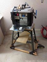 Front view of Delta 13" two-speed finishing planer mounted on portable stand