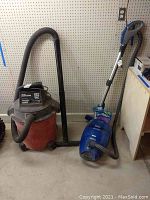 Photo of Sears Craftsman wet/dry vacuum and Kenmore HEPA vacuum side by side showing general condition and size.