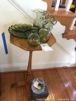 Green glass pitchers, vase, divided bowl on wooden plant stand, Waterford crystal bowl below