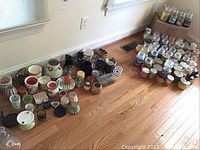 Wide view of all candles, holders and warmers arranged on floor
