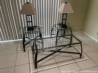 View of three glass tables and two lamps showing full set