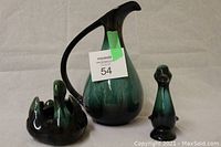 Lot of 3 Blue Mountain Pottery pieces: dark green and black glazed decorative pitcher, swan bowl, and duck figurine.