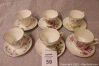 Top-down view of all 6 Duchess tea cups and saucers showing the floral pattern and gold detailing.