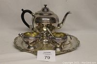 Full view of 6 piece electroplated copper tea set including teapot, sugar bowl with 2 spoons, creamer, and serving platter on neutral background.