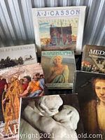 Overview of seven hardcover art and collector books arranged in a group with visible cover images, including Marilyn Monroe and various artists.