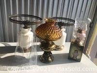 Four miscellaneous lamps displayed including two white lamps without globes, amber globe lamp, and smaller wrapped lamp