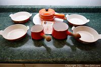 Full set on counter showing roaster, sugar pot, sauce pans, gratin dishes